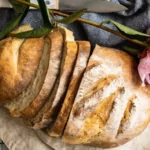 a loaf of bread on a cutting board on a counter