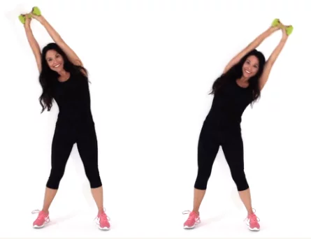 Trainer Christina Carlyle doing an overhead pendulum oblique exercise