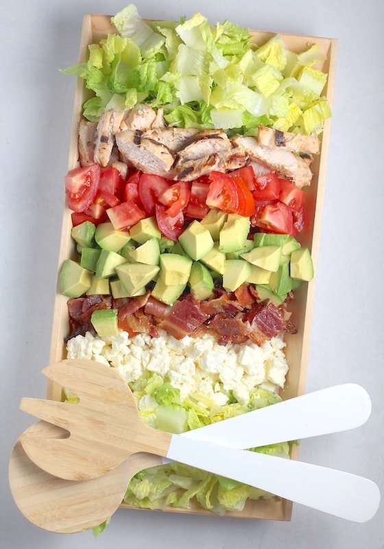 A Cobb salad flat lay on a gray table