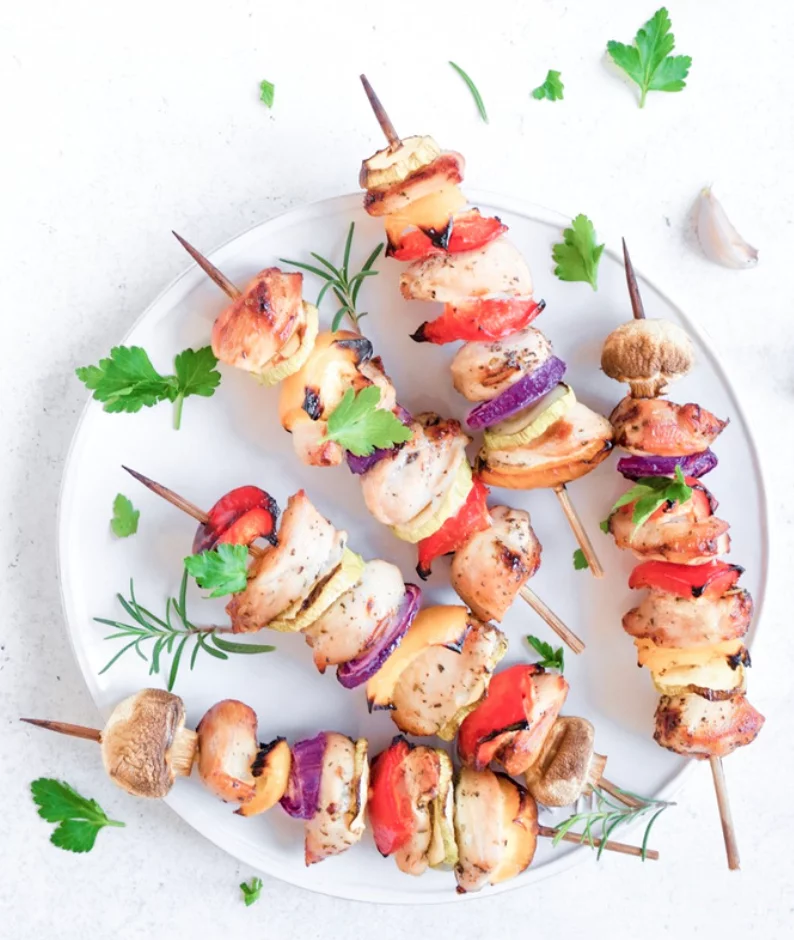 Kabobs on a plate on a kitchen counter