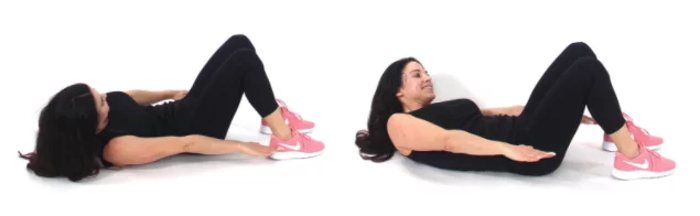 Trainer Christina Carlyle demonstrating a heel touch exercise to get rid of love handles