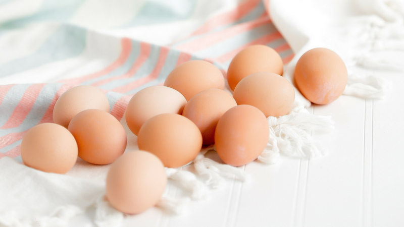 a dozen Organic, Pasture Raised Eggs on a dish towel
