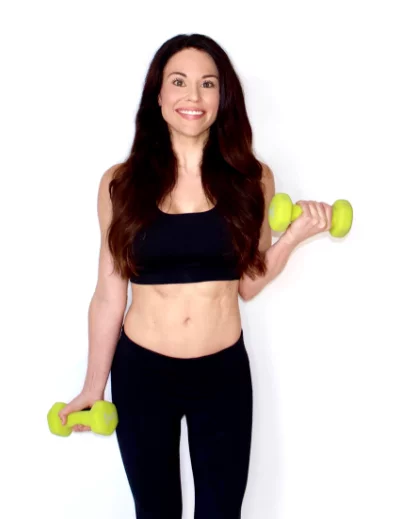 Trainer & nutritionist Christina Carlyle smiling with dumbbells