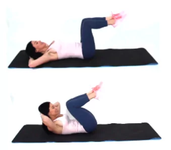 Trainer Christina Carlyle doing a Tuck Crunch Stomach Exercise