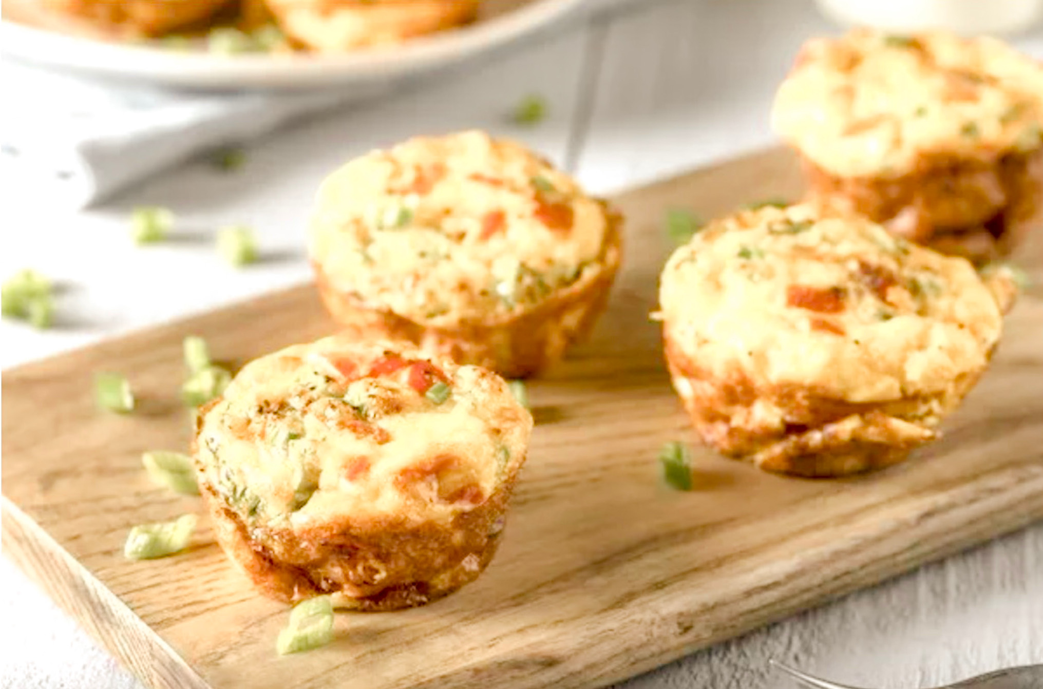 4 Egg Muffins on a cutting board on a kitchen counter