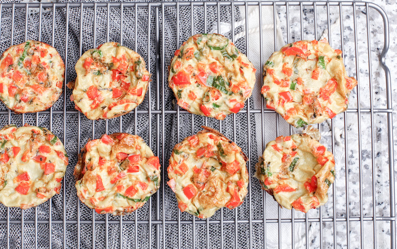 8 tomato and spinach egg muffins on a cooling rack