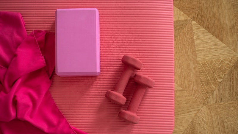 dumbbells, block and yoga mat on the floor