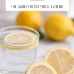 a glass of lemon water and lemons on a countertop and text that says 30 Day Lemon Water Detox