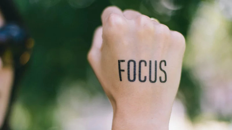 girl with the word Focus on the back of her hand