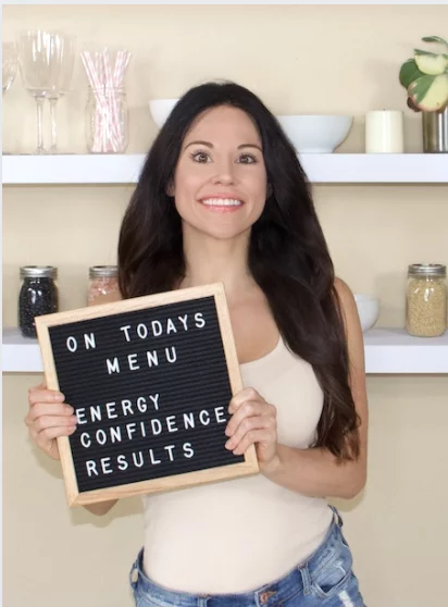 Christina Carlyle trainer Christina Carlyle smiling and holding a sign that says on today's menu energy confidence results