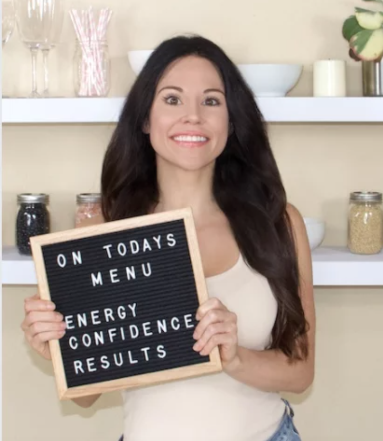 Christina Carlyle nutritionist and trainer holding a sign that says on today's menu energy, confidence, results