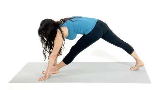 Trainer Christina Carlyle doing a Split stance inner and outer thigh stretch