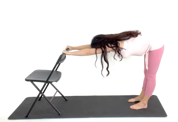 Trainer Christina Carlyle demonstrating a shoulder and lat stretch