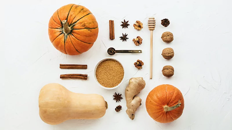 Different spices and pumpkins arranged on a countertop