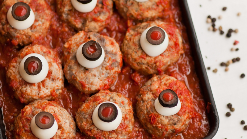 Meatballs with mozzarella and black olives that look like eyes for Halloween dinner