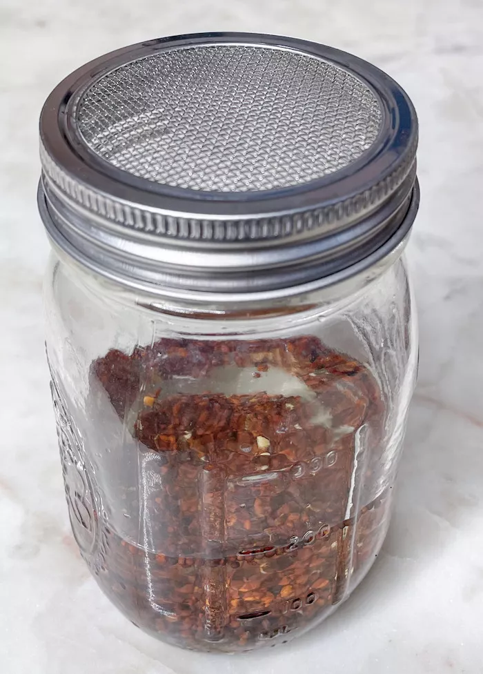 Soaking Broccoli Seeds for Sprouting in a mason jar on a countertop