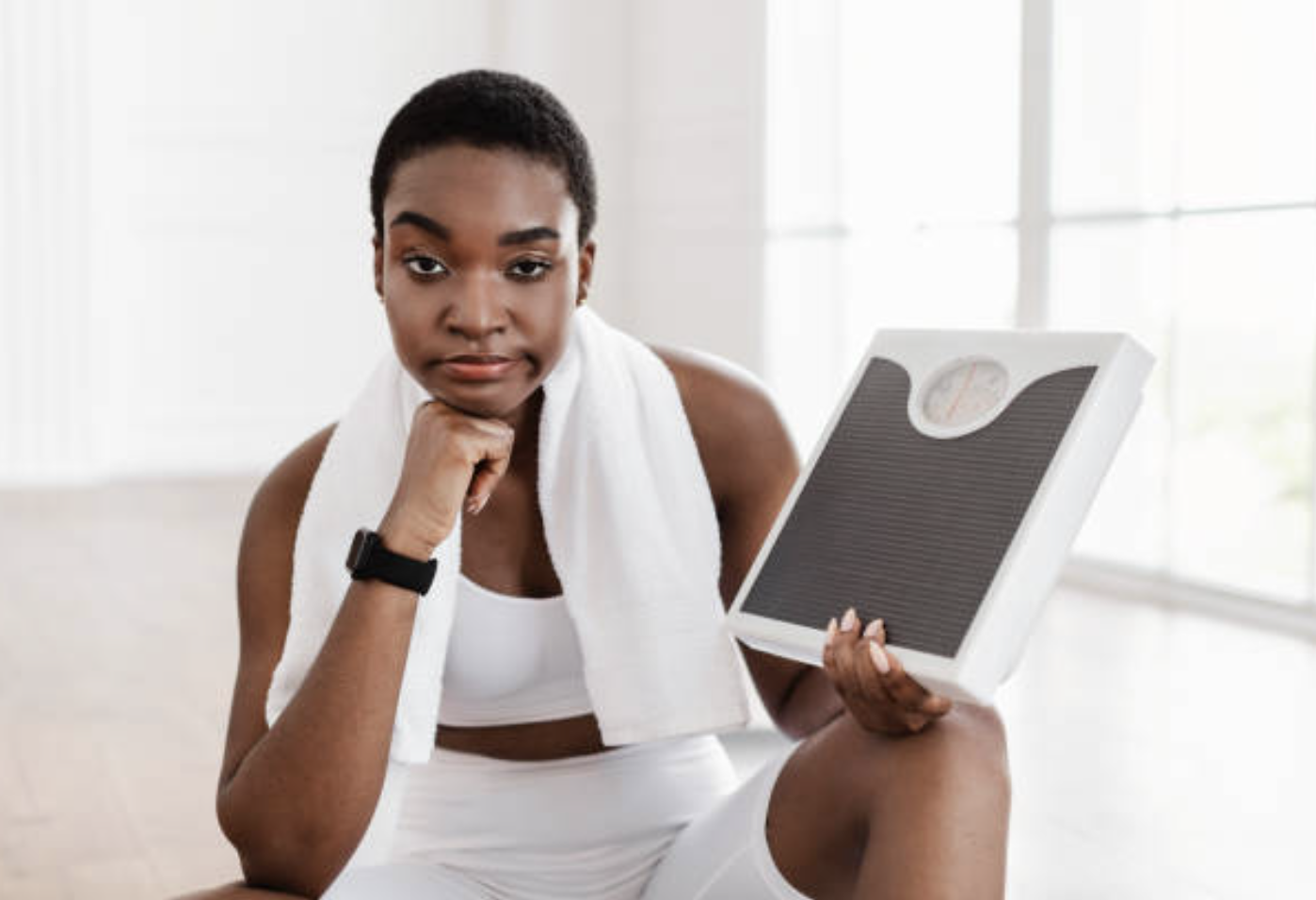 A frustrated woman holding a scale