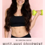 Dr. Christina Carlyle with long dark hair wearing a black sports bra and holding a lime green dumbbell in front of a soft pink background. Text on the image reads, “Dr. Christina Carlyle Must Have Equipment for Your Home Gym” and “Affordable quality equipment for the best results” with the website ChristinaCarlyle.com.