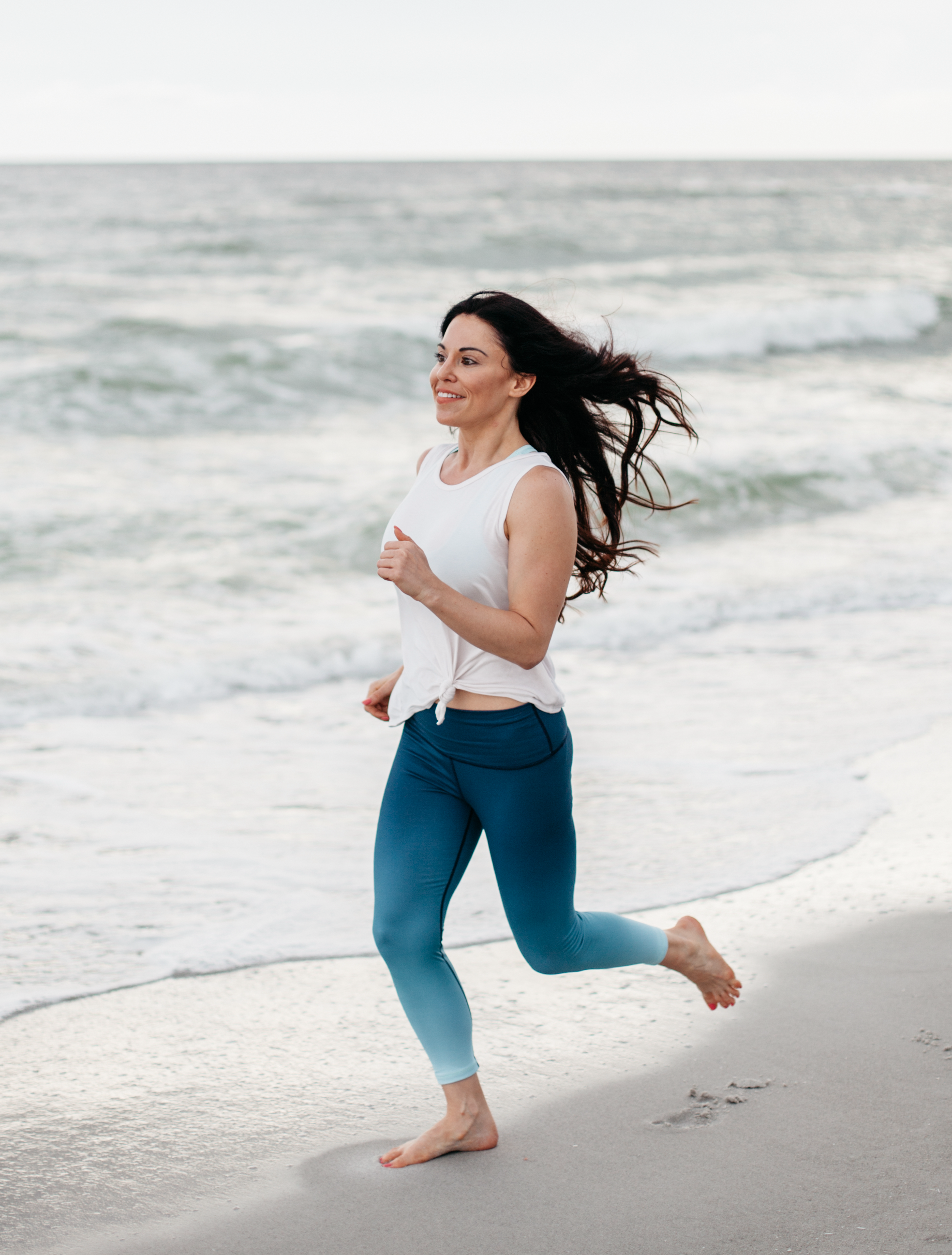 Christina Carlyle jogging on a beach