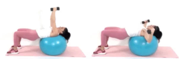 Christina Carlyle performing a chest fly exercise on a stability ball