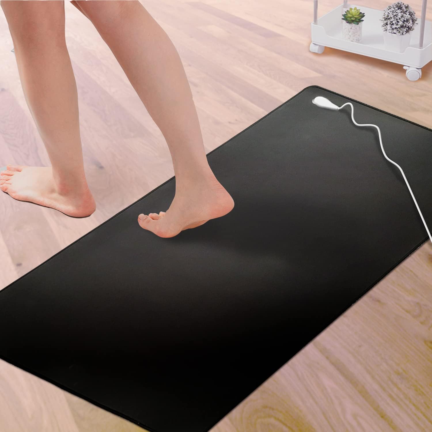 a picture of a lady stepping off a grounding mat 