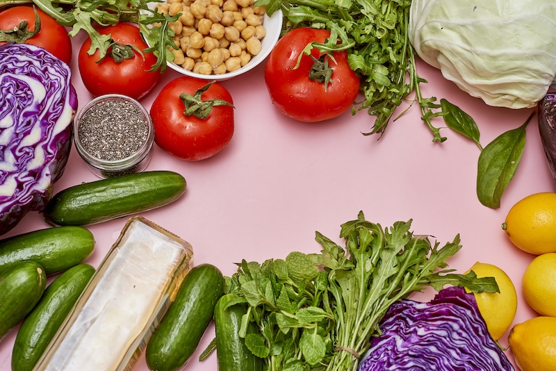 a flatlay of high fiber foods for weight loss on a pink background