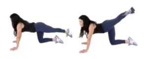 trainer Christina Carlyle doing a Crossover Extension Butt Lifting Exercise 