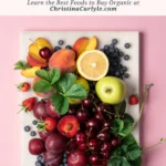 a flatlay of grapes, cherries, strawberries, apples, blueberries, and other dirty dozen fruits and text that says Updated Dirty Dozen - What to Buy Organic