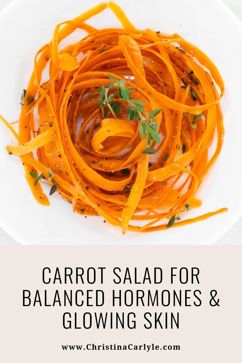Carrot Salad a bowl of carrot salad, carrot ribbons dressing in oil and herbs and text that says CARROT SALAD FOR BALANCED HORMONES & GLOWING SKIN