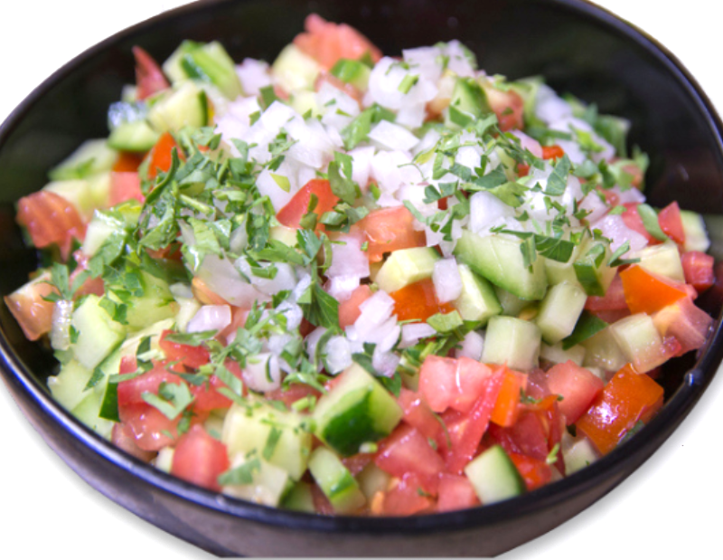 Cucumber Salsa a bowl of cucumber salsa with cucumber, onions, and tomatoes