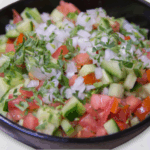 a bowl of cucumber salsa on a countertop