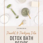a flay lay of epsom salt, bentonite clay, soap, baking soda, a jade roller, towels and other bath items and text that says Detox Bath Recipe