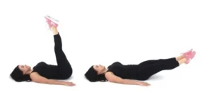 Dr. Christina Carlyle demonstrating leg lifts for core strength, legs raised and lowered with control