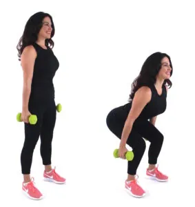 Dr. Christina Carlyle demonstrating a dumbbell squat, lowering into a squat and standing tall