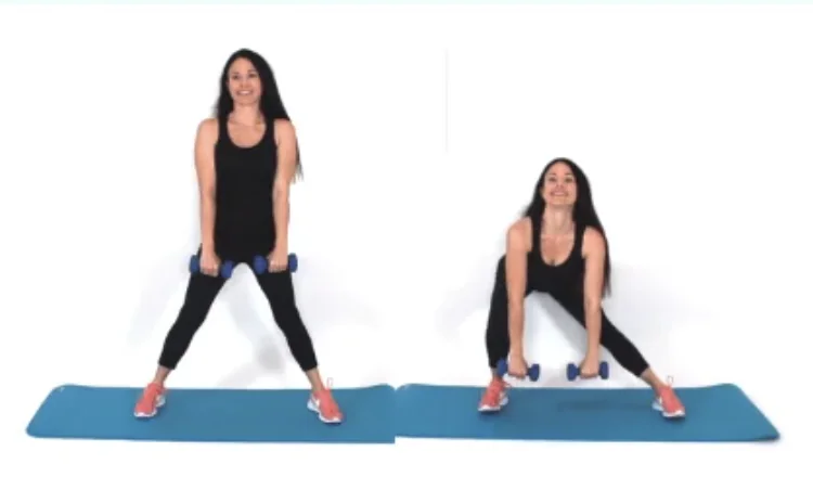 Side Lunge Exercise - Dr. Christina Carlyle Dr. Christina Carlyle performing a weighted side lunge exercise with dumbbells on a blue mat to strengthen the inner thighs, hips, and glutes to support cellulite reduction.