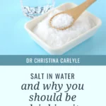 Pinterest graphic for Dr Christina Carlyle featuring a glass of water, a bowl of salt with a wooden spoon, and the text “Salt in Water and Why You Should Be Drinking It” with “Learn More on ChristinaCarlyle.com.”