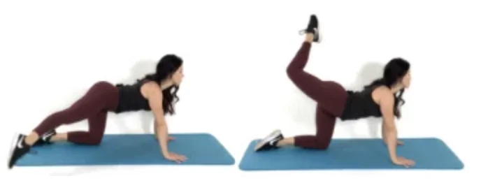 Dr. Christina Carlyle demonstrates cross over leg extensions on a yoga mat, extending one leg behind and across the body to target the glutes, hips, and core.