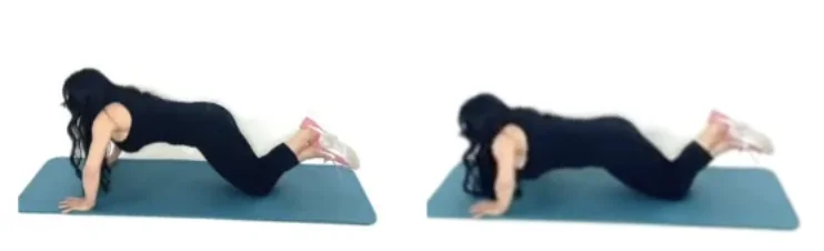 Dr. Christina Carlyle demonstrating a modified push up on her knees on a blue exercise mat for an upper body calisthenics workout.
