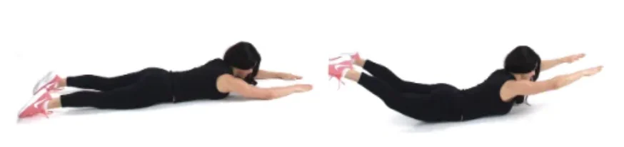 Dr. Christina Carlyle demonstrating a superman exercise on the floor for a back and core calisthenics workout.